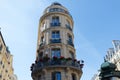 The flower-decked facade of traditional French house with typical balconies and windows. Paris.