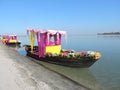 Flower decorated boats are kept for tourists on the bank of river Brahmaputra in Dibrusaikhowa National park, Assam, India.