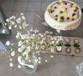 Flower decoration in focus with cake and party snacks on the background Royalty Free Stock Photo