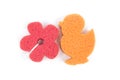 Flower and duck shaped bath sponge isolated on white background, surface. Red and orange bathing sponge. Royalty Free Stock Photo