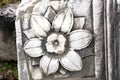 Flower engraved on marble stone, antique stone block, stone flower