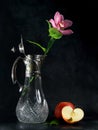 Flower in flagon and apples.