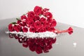 Flower heart with snow. Symbol love and valentines day. Red roses collected in the shape of a heart. Sample greeting card. Heart- Royalty Free Stock Photo