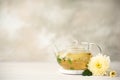 flower herbal tea with chrysanthemum petals in a glass teapot