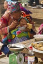 A flower Hmong feeding her baby at Bac Ha Royalty Free Stock Photo