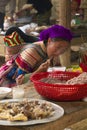 A flower hmong and her baby eating at Bac Ha Week end market Royalty Free Stock Photo