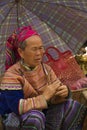 A flower Hmong women under an umbrella at Bac Ha Royalty Free Stock Photo