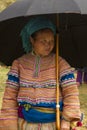 A flower Hmong women under an umbrella at Bac Ha Royalty Free Stock Photo