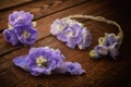 Flower jewelry on dark wood background