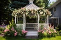 a flower-laden gazebo in a backyard wedding