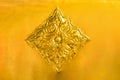 Flower and leaf pattern in Thai Lanna style carved on gold metal plate background decorate on golden pagoda in Buddhist temple