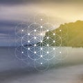 Flower of life sacred geometry illustration with intelocking circles and light dots in front of photographic background. Hipster Royalty Free Stock Photo