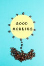 Flower made with coffee beans, the words good morning are standing on the blossom, wake up, having an espresso for breakfast, hot