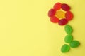 Flower made with tasty jelly candies on color background, flat lay Royalty Free Stock Photo