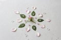 Flower Mandala on Gray Background. Geometrical floral composition. Rose laid out on the petals. Stones rose quartz and rock