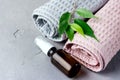 Flower Oil in Cosmetic Bottles Pink and Gray Towels on Gray Background Cosmetic or Spa Concept Horizontal Above Royalty Free Stock Photo