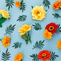Flower pattern made of flowers with leaves on blue background. Flat lay, top view Royalty Free Stock Photo