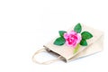 Flower pink rose on the brown paper bag isolated on the white b Royalty Free Stock Photo