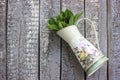 Flower pot filled with sage leafs on wood background