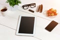 Flower pot, glasses, tablet, smart on white desktop Royalty Free Stock Photo