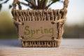 Flower pot holding a spring sign Royalty Free Stock Photo