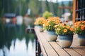 flower pots on a cottage dock with clear lake waters Royalty Free Stock Photo
