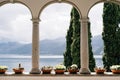 Flower pots with succulents in arches with columns overlooking Lake Como in Italy.