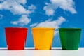 Flower pots. three empty plastic cups against the sky and clouds Royalty Free Stock Photo