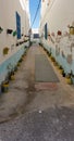 Flower pots to decorate a narrow shady alley in the old town, medina