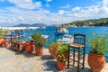 Flower pots on and view of fishing boats anchoring in Kokkari bay, Samos island, Greece Royalty Free Stock Photo