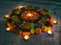 Flower Rangoli with lamps on Diwali, India