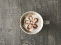 Flower shaped design on a cup of cappuccino coffee
