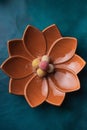 a flower shaped dish on a turquoise tablecloth with some sugar