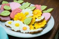 Flower shaped gingerbread cookies on white plate. Candy bar with sweets for girl birthday Royalty Free Stock Photo