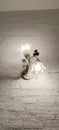 A flower shaped lamp adorns the rough plaster wall Royalty Free Stock Photo