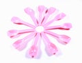 A flower shaped layer of pink color plastic baby spoons.