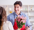 The flower shop assistant selling flowers to female customer Royalty Free Stock Photo