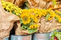 Flower shop, close-up of fresh flowers in buckets, yellow decorative sunflowers Royalty Free Stock Photo