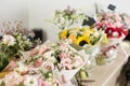 Bouquets on table, florist business. Different varieties fresh spring flowers. Delivery service. Flower shop concept. Royalty Free Stock Photo