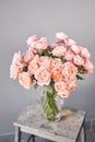 Flower shop delivery concept. Roses of multicolor, pastel pink and pale orange color. Lots of buds. Floral natural