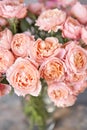 Flower shop delivery concept. Roses of multicolor, pastel pink and pale orange color. Lots of buds. Floral natural