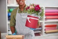 Flower store shopkeeper selling a roses pot Royalty Free Stock Photo