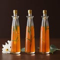 Flower syrup in three long-neck transparent bottles.