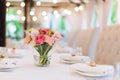 Flower table decorations for holidays and wedding dinner. Table set for holiday, event, party or wedding reception in Royalty Free Stock Photo