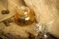 Flower tea brewed in a glass teapot on a background of homespun fabric with a rough texture. Close up Royalty Free Stock Photo