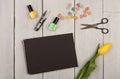 Flower tulip, blank black note pad, scissors, nail polish and bu Royalty Free Stock Photo