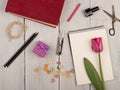 Flower tulip, note pad, book, scissors, nail polish and buttons