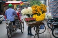 Flower vendor on Hanoi old town street at early morning