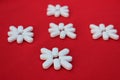 Flower of white pills on a red background. Medicine concept. Five flowers from drugs top view. Royalty Free Stock Photo