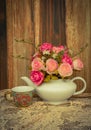 Flower in a white tea pot and vintage , cozy home rustic decor, Royalty Free Stock Photo